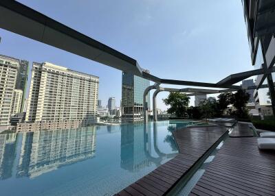 Modern high-rise building with an infinity pool overlooking the city