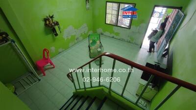 Entryway with green walls and staircase