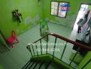 Entryway with green walls and staircase