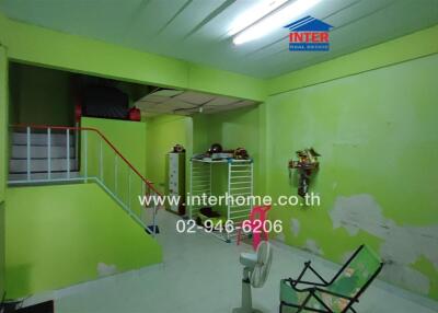 Living area with green walls and stair access
