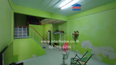 Living area with green walls and stair access