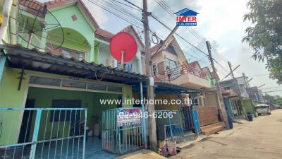 Exterior view of residential houses with colorful facades and a street perspective