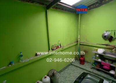 Small kitchen with green walls and various kitchen items