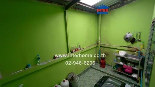 Small kitchen with green walls and various kitchen items