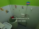 Bathroom with green and white walls, stickers, and basic amenities