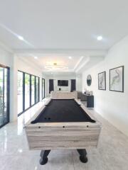 Stylish recreation room with pool table and modern decor