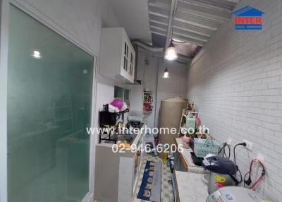 Small kitchen with white brick walls and modern appliances