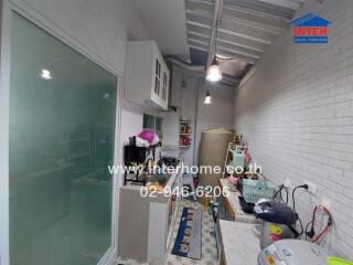 Small kitchen with white brick walls and modern appliances