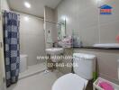 Modern bathroom with light brown tiles, a mirror, and various toiletries.