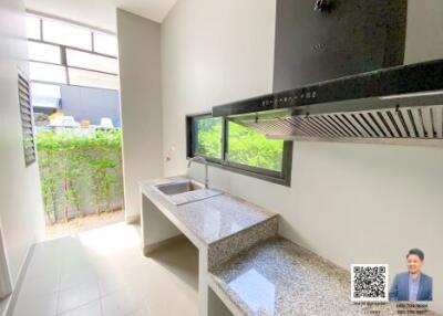 Modern kitchen with granite countertops and large windows