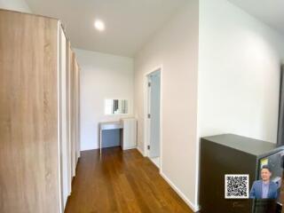 Modern bedroom with wooden flooring and a small vanity table