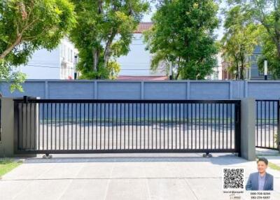 Gated entry with trees in the background