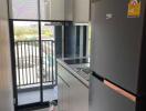 Modern kitchen with balcony access and appliances