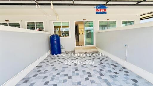 Exterior of a house with tiled flooring and a water tank