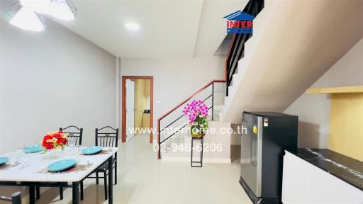 Modern dining area with dining table and nearby kitchen