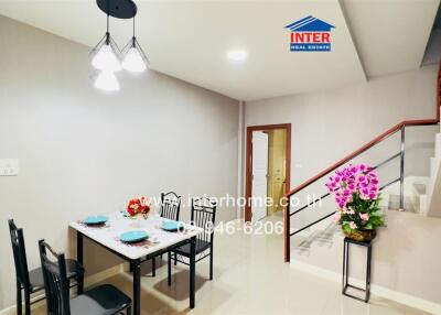 Well-lit dining area with a table set for four and modern lighting