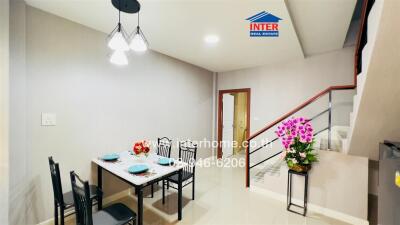 Well-lit dining area with a table set for four and modern lighting