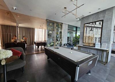 Modern recreational room with pool table and seating area
