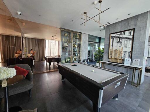 Modern recreational room with pool table and seating area