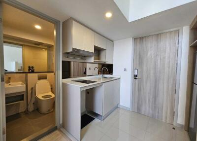 Modern compact kitchen with adjacent bathroom