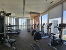 Modern gym with various exercise equipment and city views