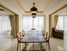 Modern dining area with wooden table and chairs, pendant lighting, and large windows