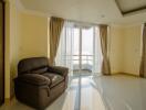 Spacious living room with balcony access and large windows