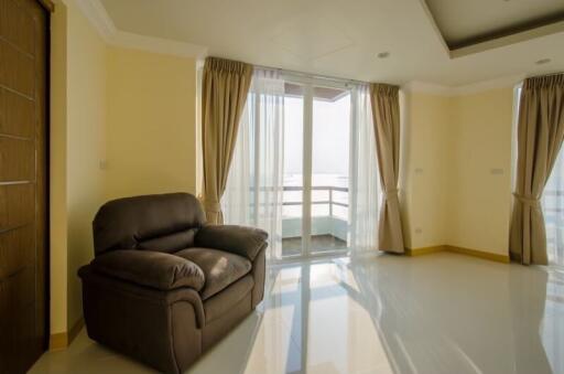 Spacious living room with balcony access and large windows