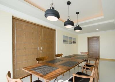 Stylish dining room with wooden table and modern pendant lights