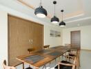 Stylish dining room with wooden table and modern pendant lights