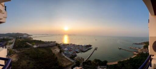 Scenic sunset view from apartment balcony over a coastal area