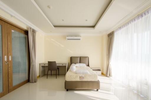 Modern bedroom with large windows and natural light