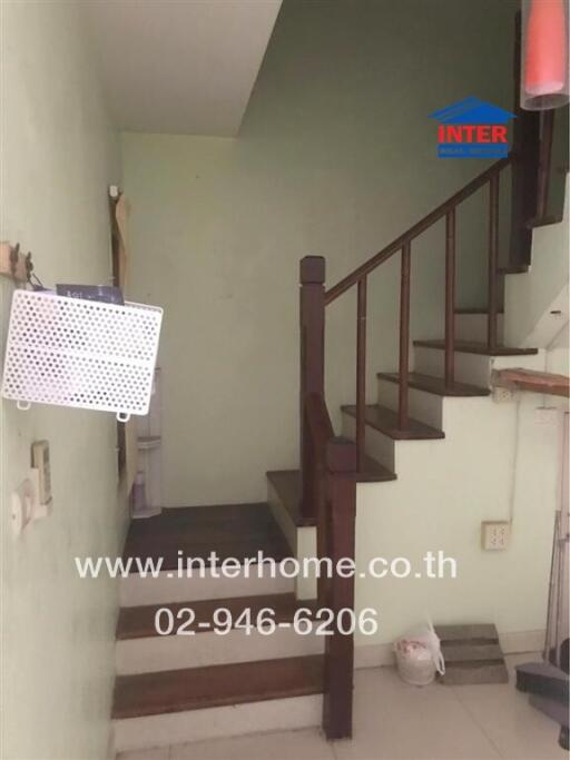 Indoor staircase with wooden railing