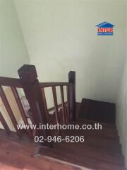 Wooden staircase with dark handrail