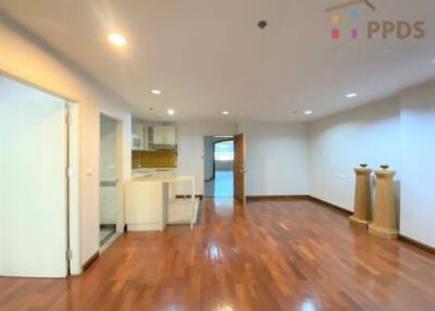 Spacious living room with wooden floors and recessed lighting