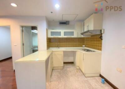 Kitchen with white cabinets and yellow backsplash