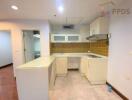 Kitchen with white cabinets and yellow backsplash