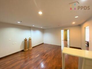 Spacious living area with wooden flooring and recessed lighting