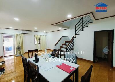 Spacious living and dining area with staircase