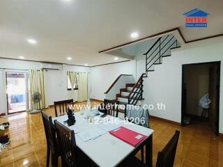 Spacious living and dining area with staircase