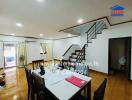 Spacious living and dining area with staircase