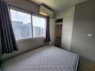 Modern bedroom with large window and air conditioning unit