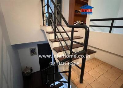 Staircase with metal railing and wooden steps