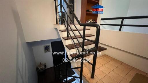 Staircase with metal railing and wooden steps