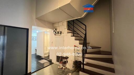 Staircase area with a view of a hallway and bathroom