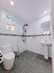 Modern bathroom with shower and tile flooring