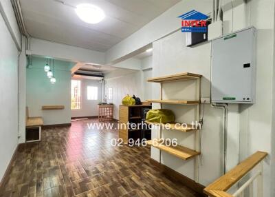 Modern living area with wooden flooring and built-in shelves