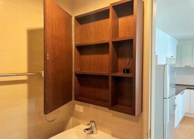 Bathroom with open wooden storage cabinet