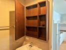 Bathroom with open wooden storage cabinet