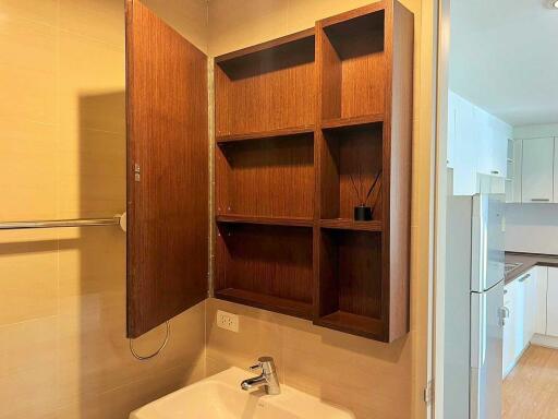 Bathroom with open wooden storage cabinet